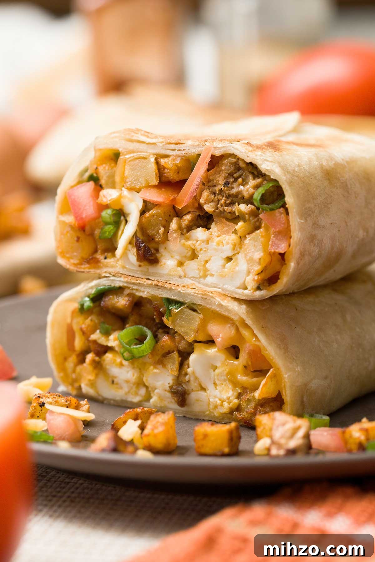 High-Protein Breakfast Burrito with Crispy Potato Filling 4 A view of the inside of two halves of a breakfast burrito stacked on top of each other.