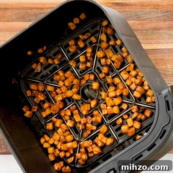 High-Protein Breakfast Burrito with Crispy Potato Filling 6 Taking the crispy potatoes out of the air fryer.
