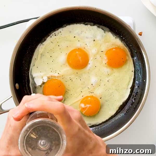 High-Protein Breakfast Burrito with Crispy Potato Filling 7 Seasoning the eggs in a skillet.