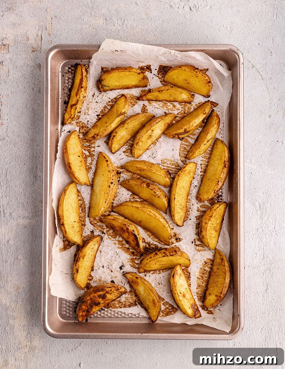 Crispy Oven-Baked Potato Wedges with Smoky Chipotle Sauce 15 roasted potato wedges on a sheet pan