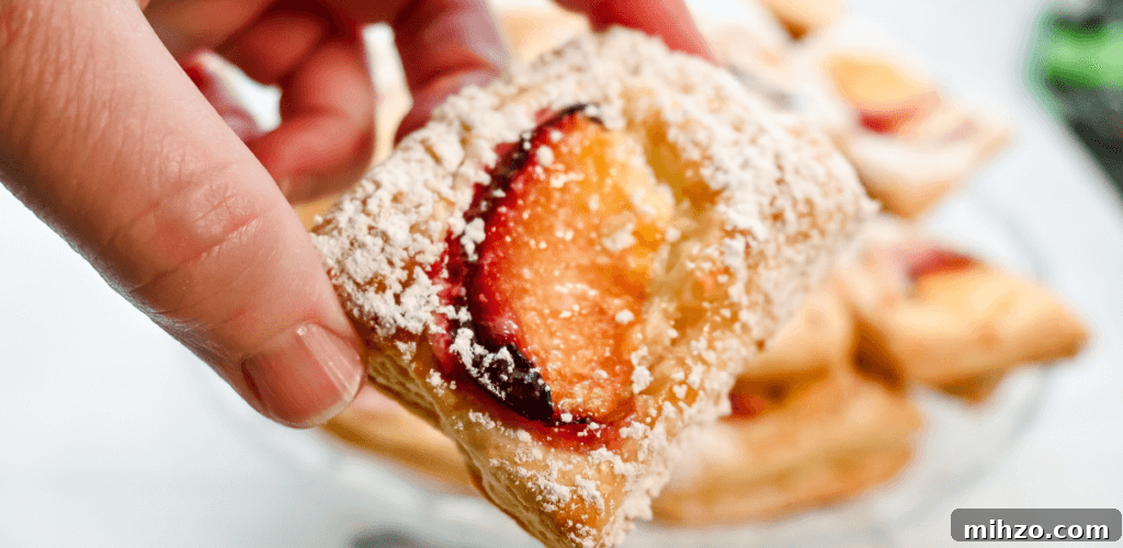 Close up of a hand holding a single mini tart
