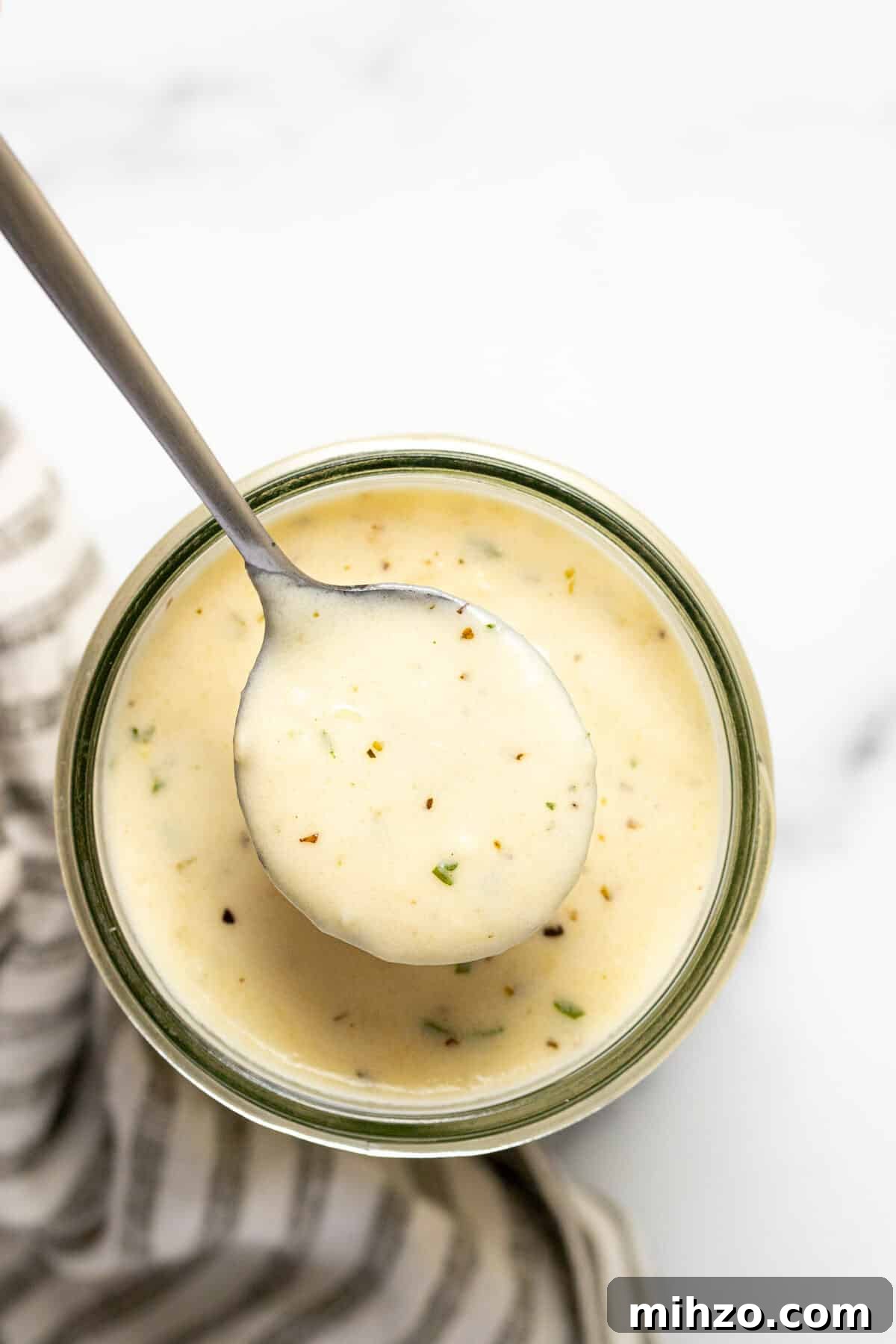 15-Minute Garlic Parmesan Sauce Recipe for Quick Dinners 2 Overhead shot of a mason jar filled with garlic Parmesan cream sauce