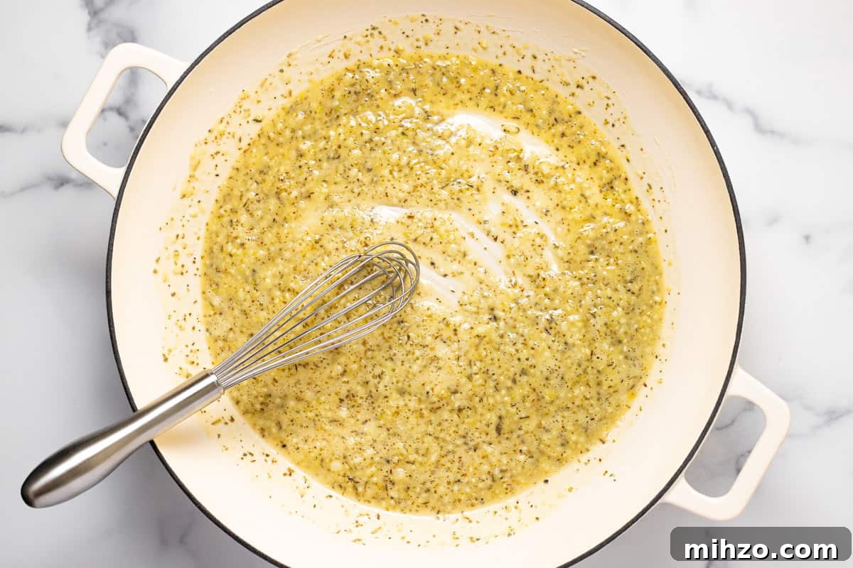 15-Minute Garlic Parmesan Sauce Recipe for Quick Dinners 5 Large white sauté pan filled with sautéed garlic dried herbs and flour