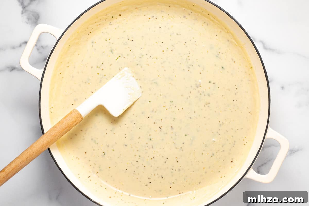 15-Minute Garlic Parmesan Sauce Recipe for Quick Dinners 8 Large white sauté pan filled with creamy Parmesan garlic sauce