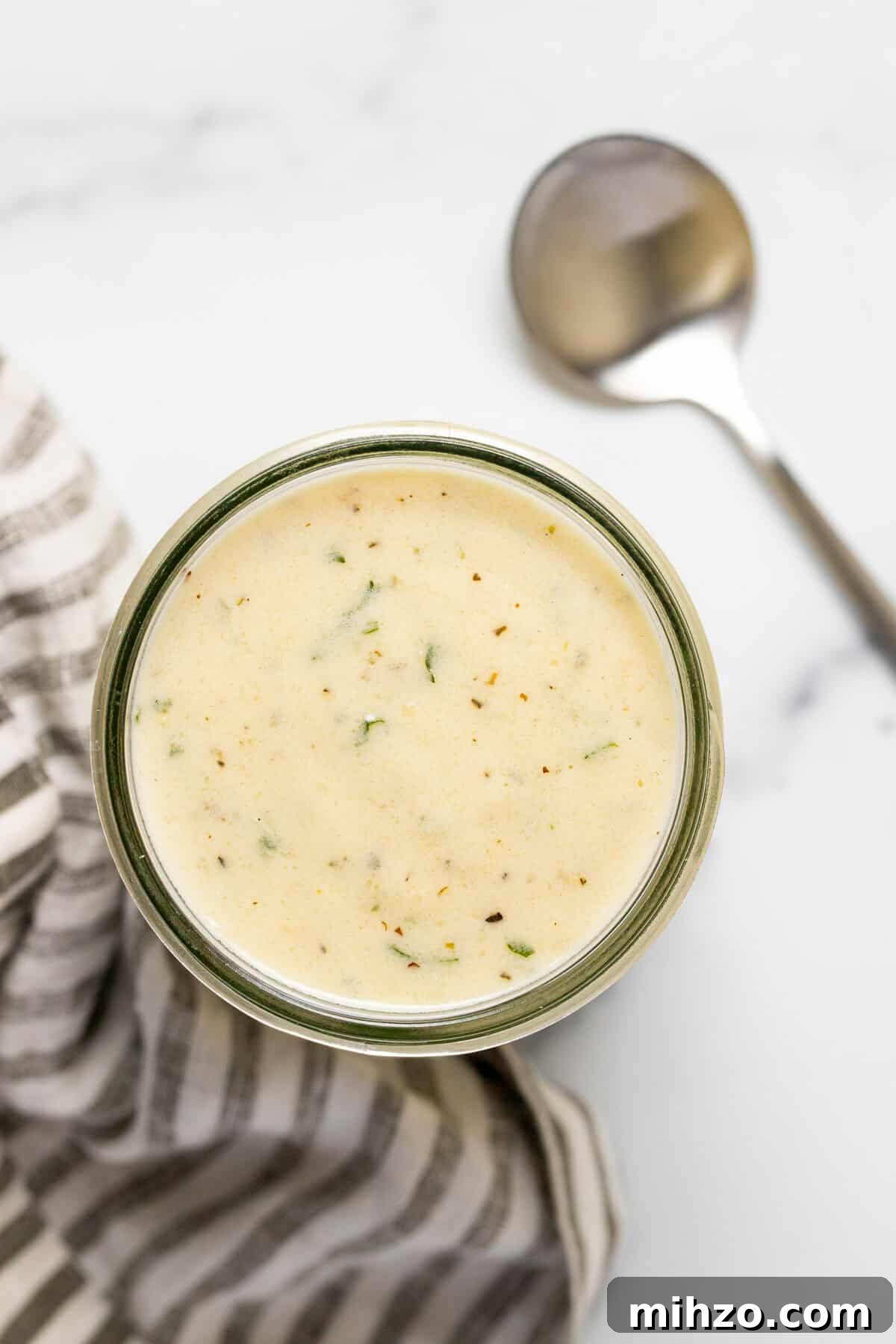 15-Minute Garlic Parmesan Sauce Recipe for Quick Dinners 9 Overhead shot of a mason jar filled with garlic Parmesan cream sauce