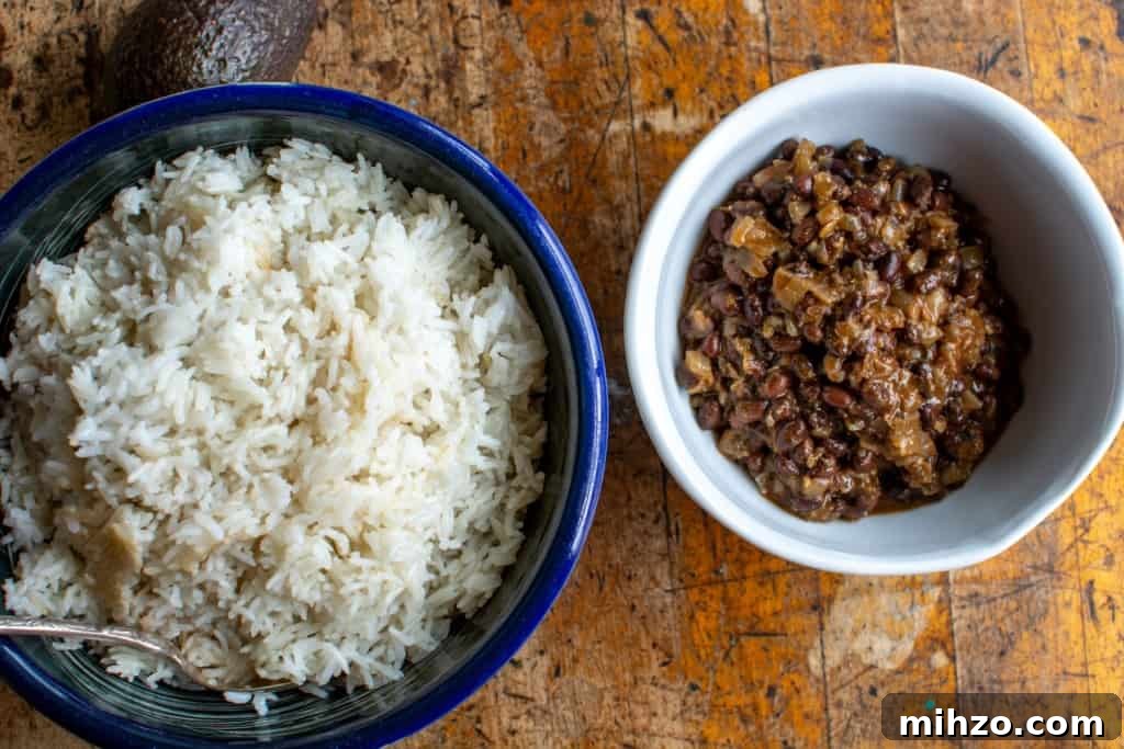 Protein-Packed Vegetarian Black Bean Burrito Bowl Recipe 5 The rice and the black beans in bowls on a wood table.
