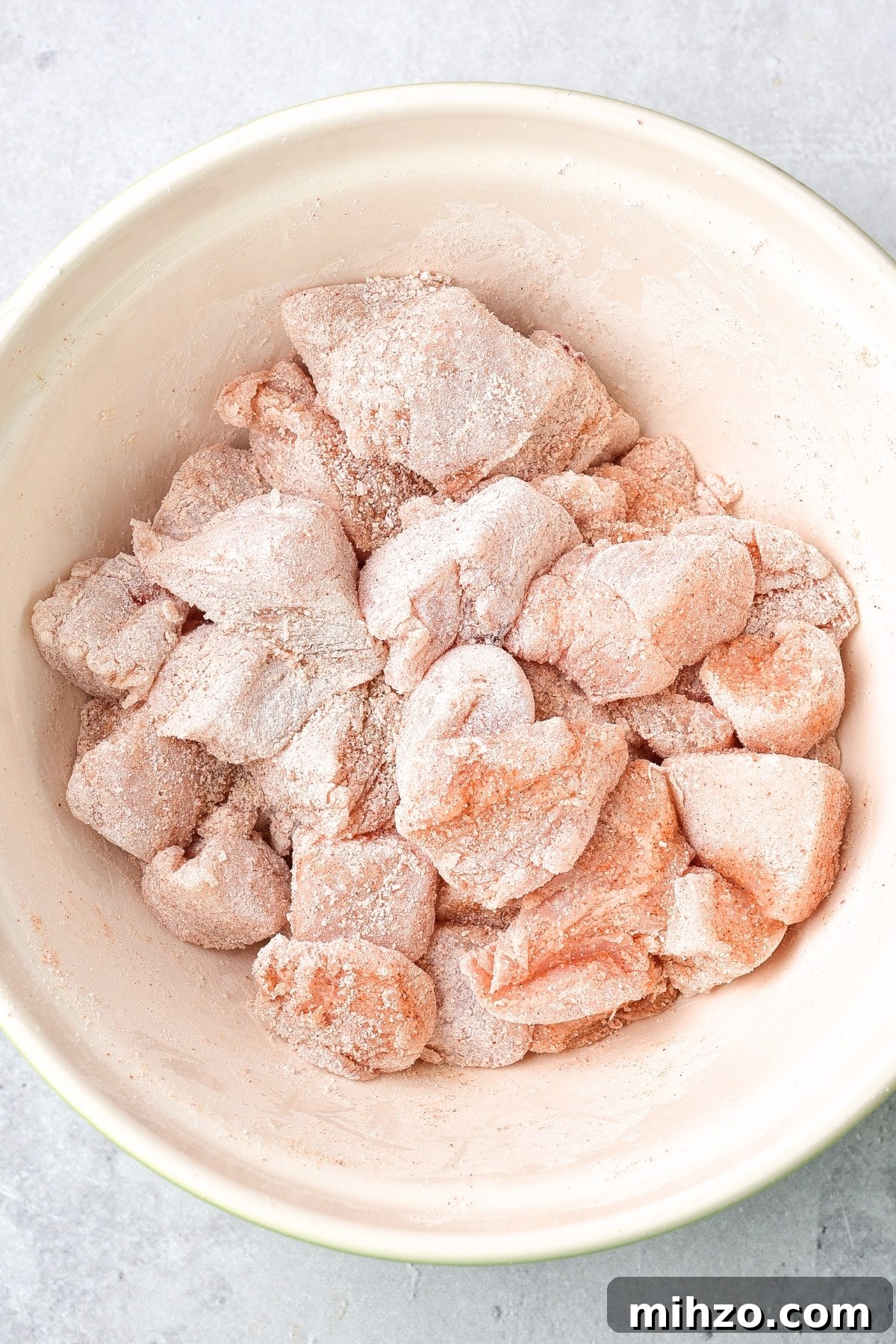 How to Make Buffalo Chicken Bites in Air Fryer (Gluten-Free, Dairy-Free) Coated chicken bites in bowl.