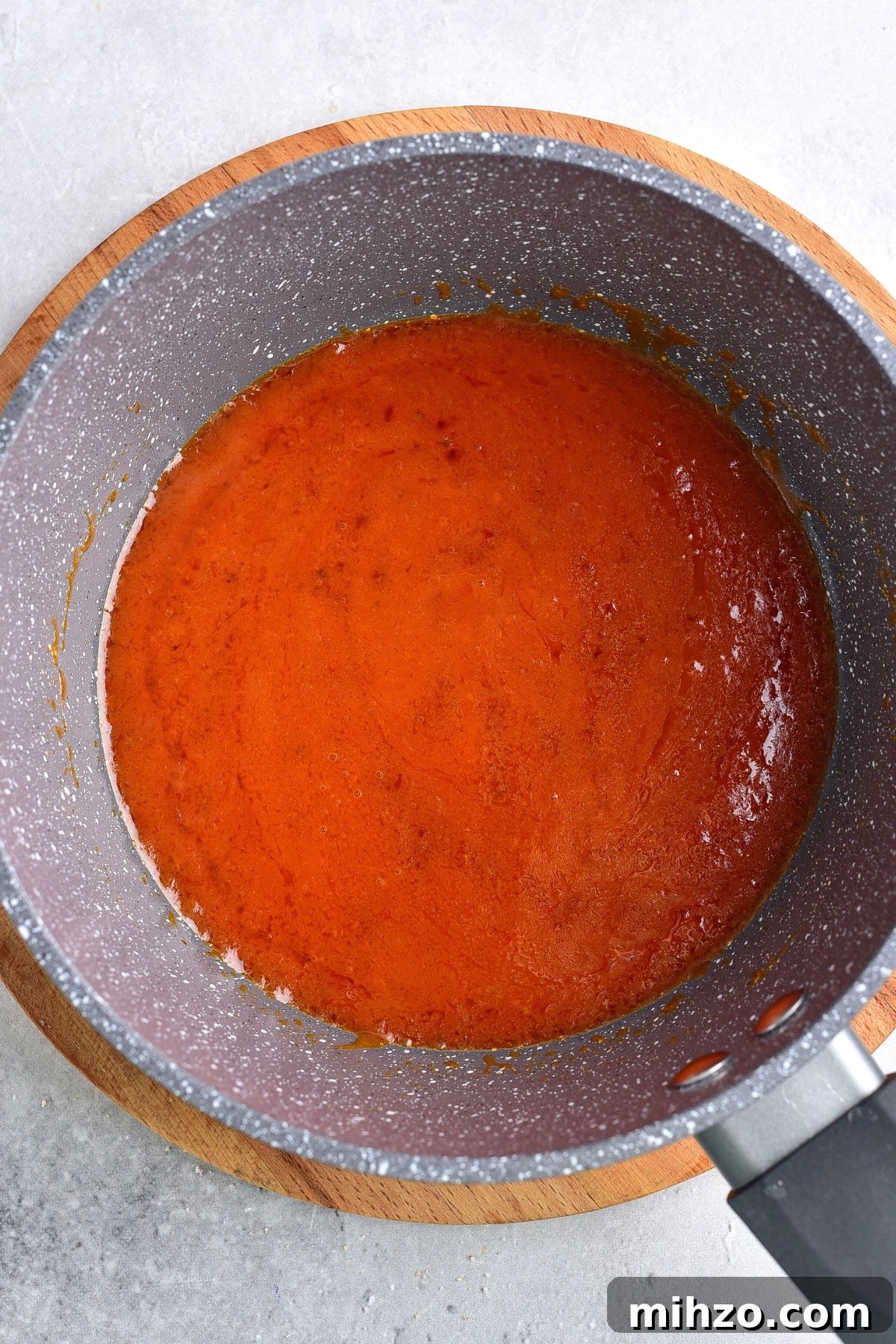 Air Fryer Buffalo Chicken (Gluten-Free, Dairy-Free) Preparing Buffalo sauce in saucepan.