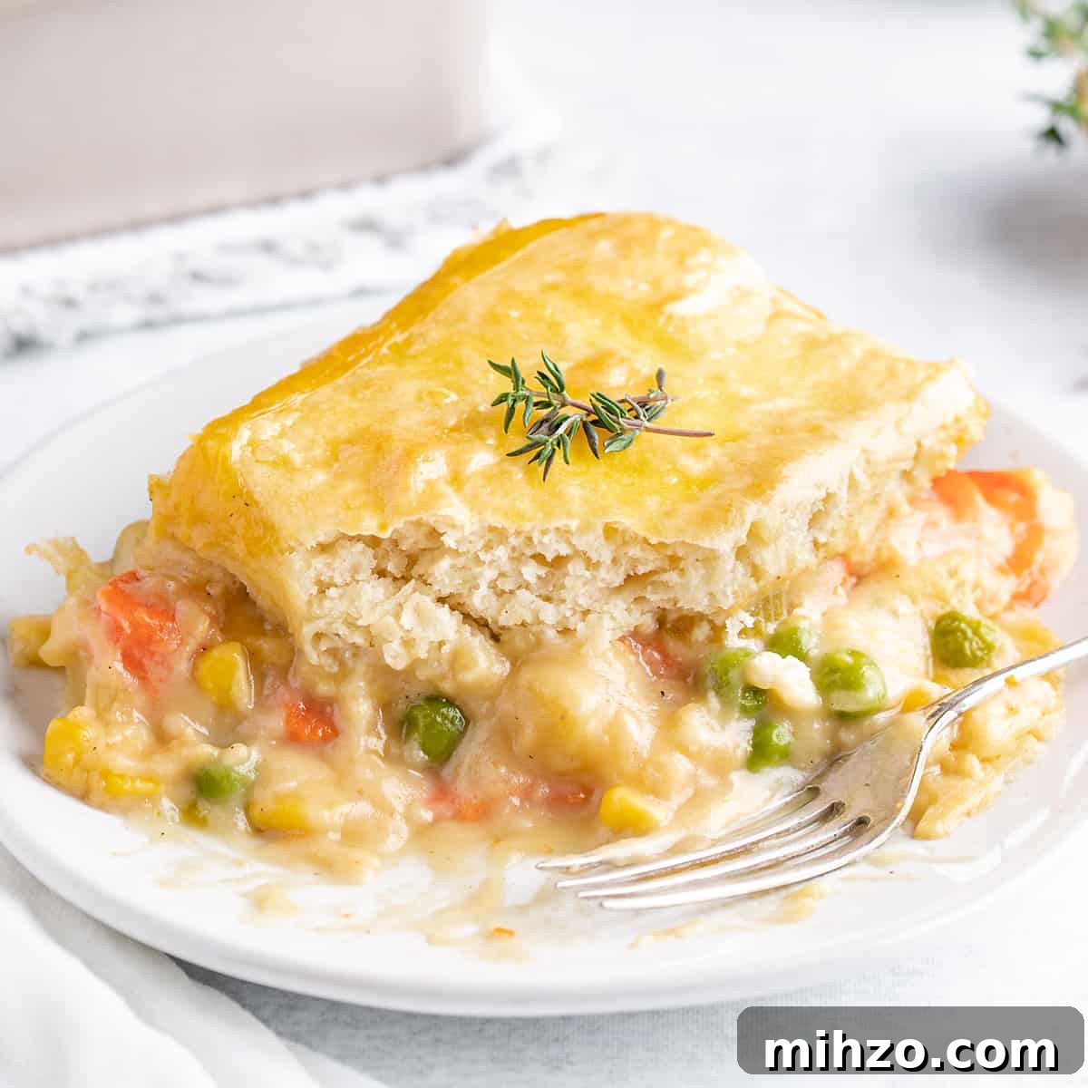 Hearty Vegetable Pot Pie Recipe with Flaky Crust 16 a serving of Vegetable Pot Pie on a plate with a fork