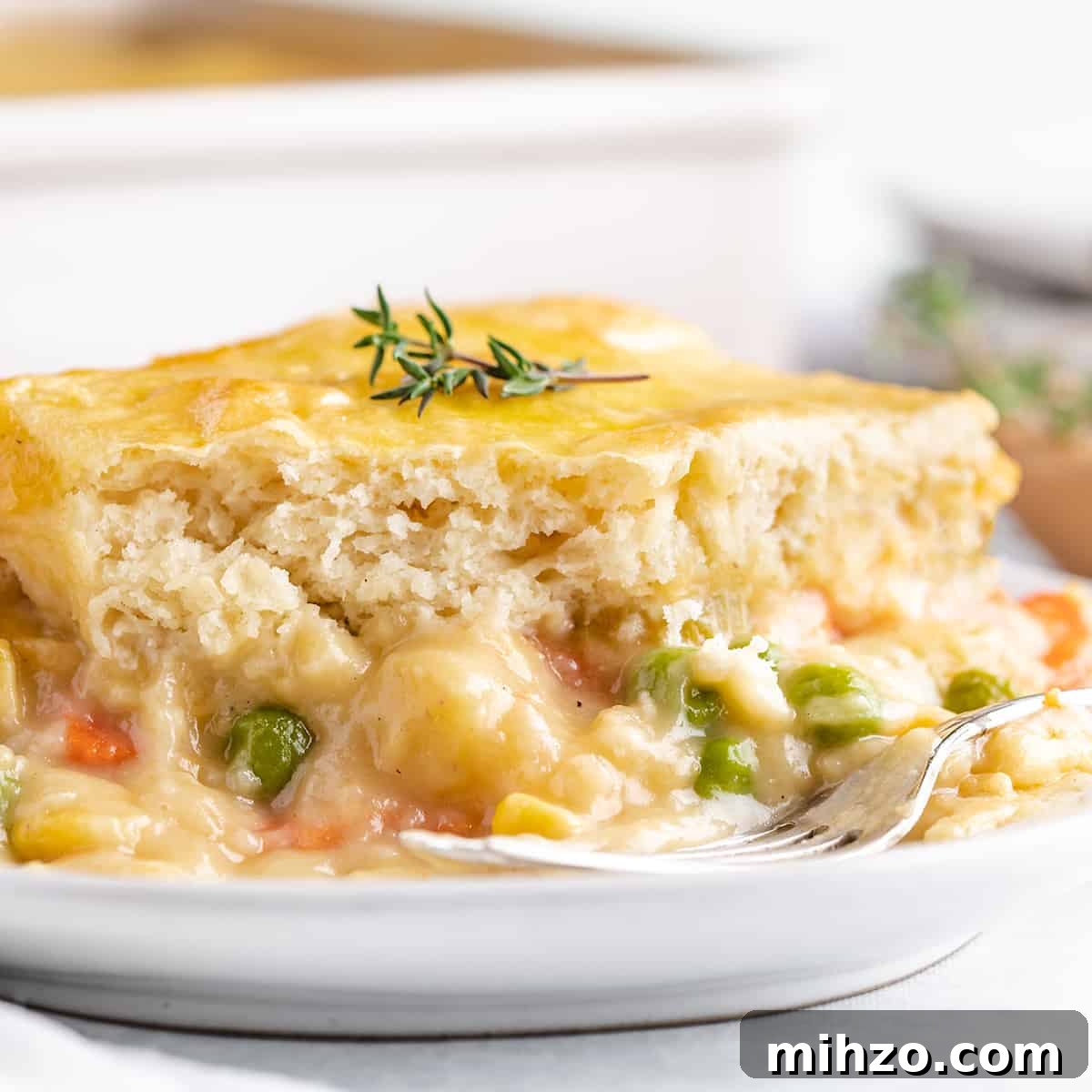Hearty Vegetable Pot Pie Recipe with Flaky Crust 17 a serving of Vegetable Pot Pie on a plate with a fork