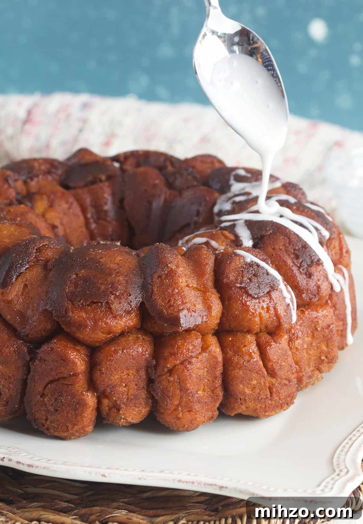 Perfect Sticky Monkey Bread Recipe for Warm Gatherings 3 Icing is being drizzled on top of baked monkey bread.
