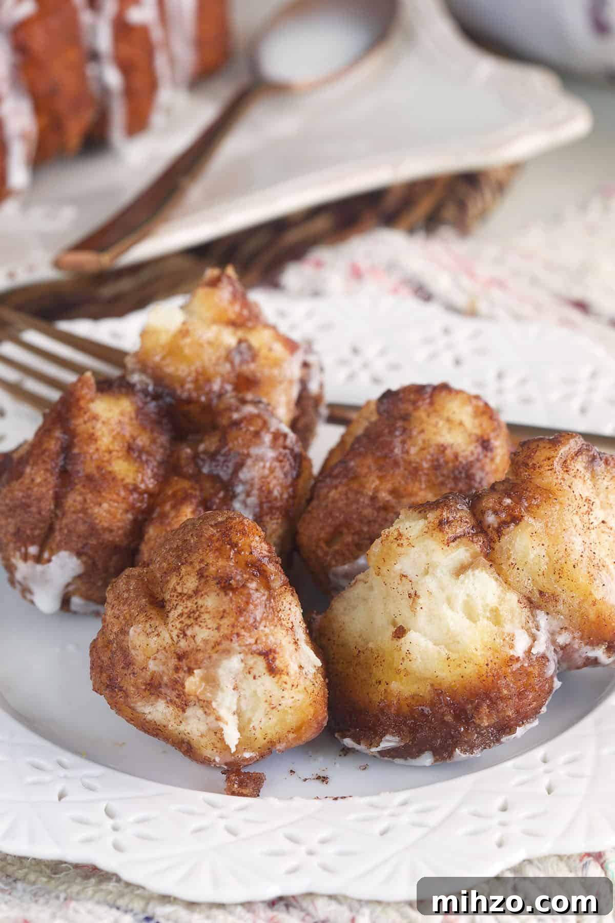 Perfect Sticky Monkey Bread Recipe for Warm Gatherings 5 A white plate is topped with bites of monkey bread.