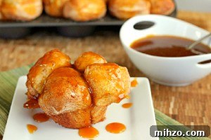 Pumpkin Caramel Monkey Bread Muffins with bowl of caramel in background