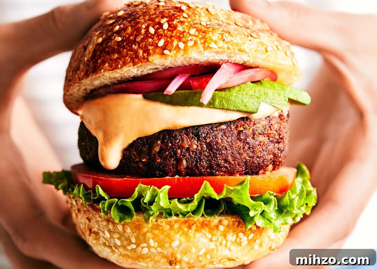 Quick Sriracha Aioli Recipe with 3 Ingredients 10 Hands holding a Chipotle Black Bean Burger.
