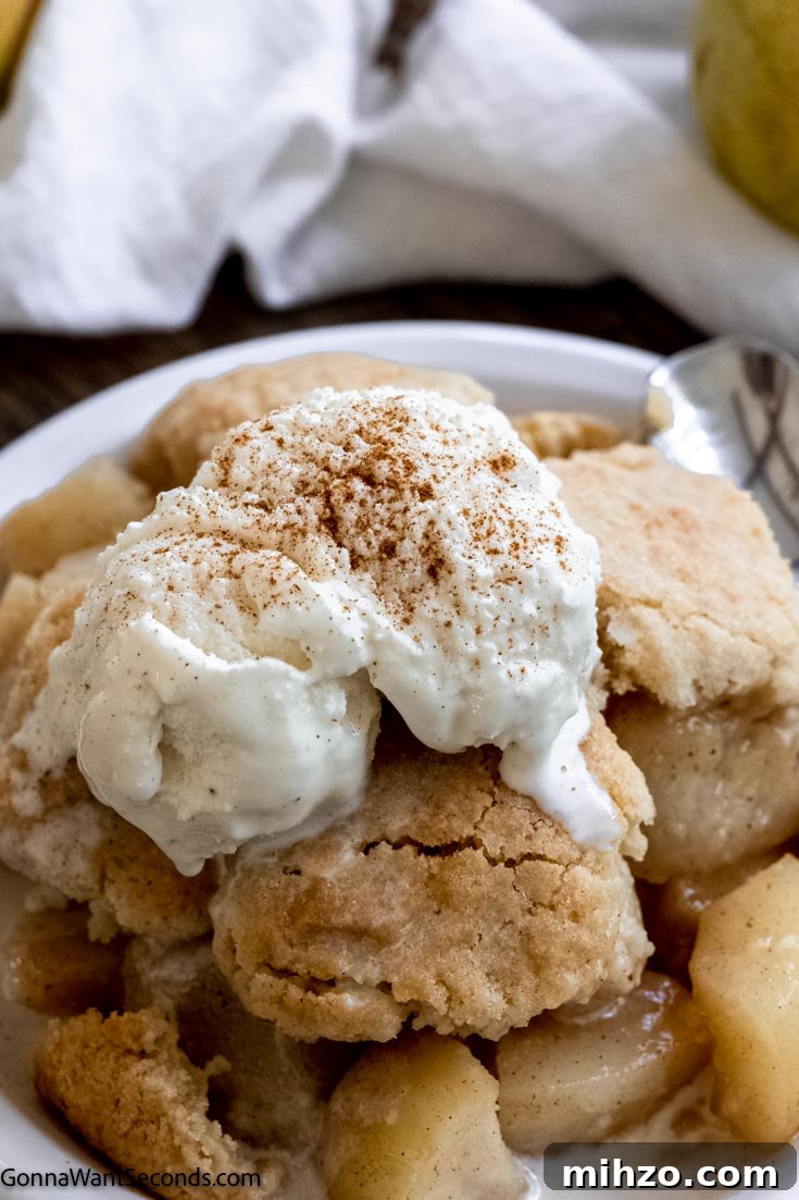 This pear cobbler is a fall twist on one of the most easy going desserts around. Tender pears, golden topping, and a perfect cobbler are all yours. #cobblerrecipes #pearcobbler southern pear cobbler with vanilla ice cream on top