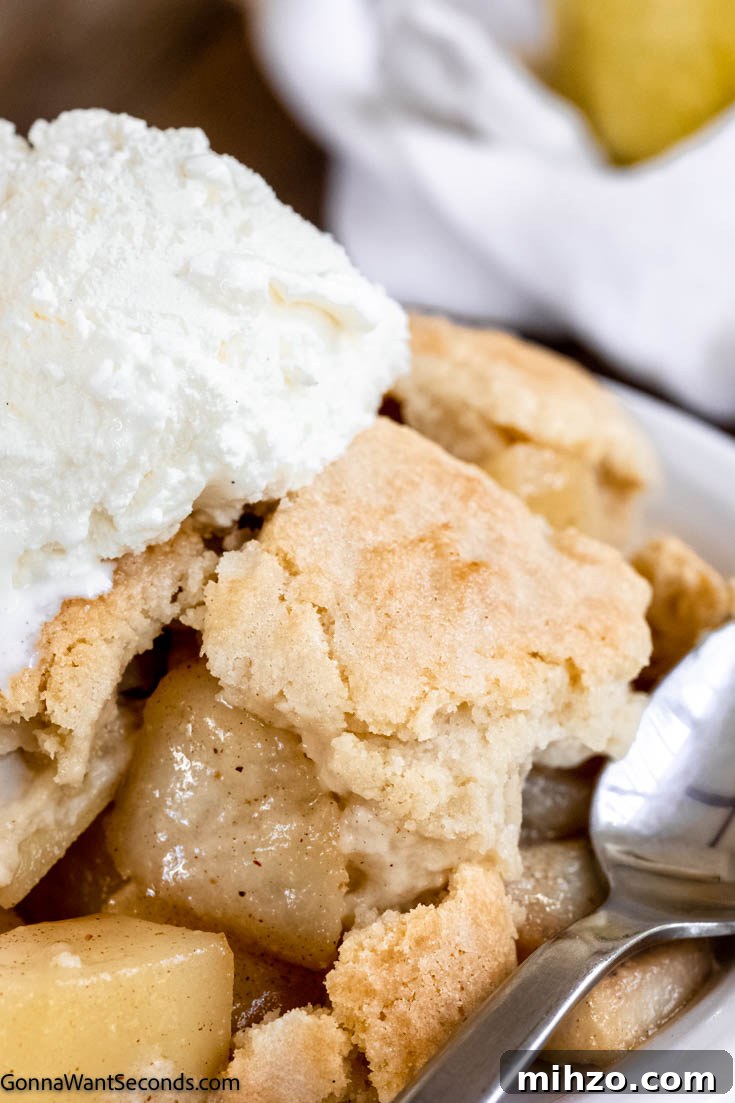 This pear cobbler is a fall twist on one of the most easy going desserts around. Tender pears, golden topping, and a perfect cobbler are all yours. #cobblerrecipes #pearcobbler pear cobbler with fresh pears and vanilla ice cream on top