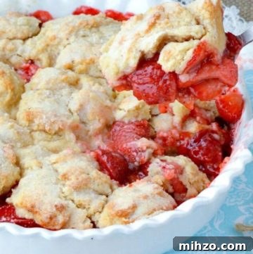 Rustic Pear Cobbler Recipe with Cinnamon and Brown Sugar 6 Scooping a portion of Strawberry Cobbler