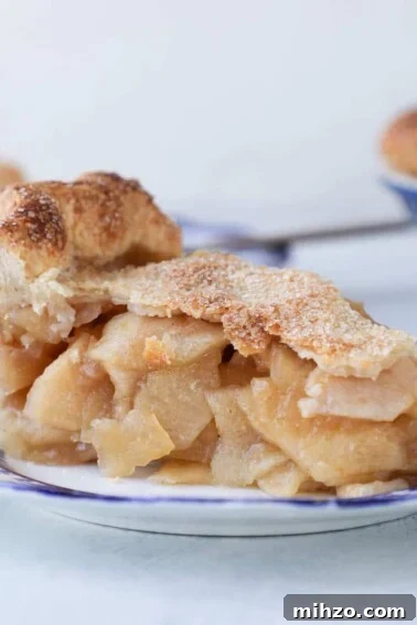 Mile High Apple Pie slice on blue plate.