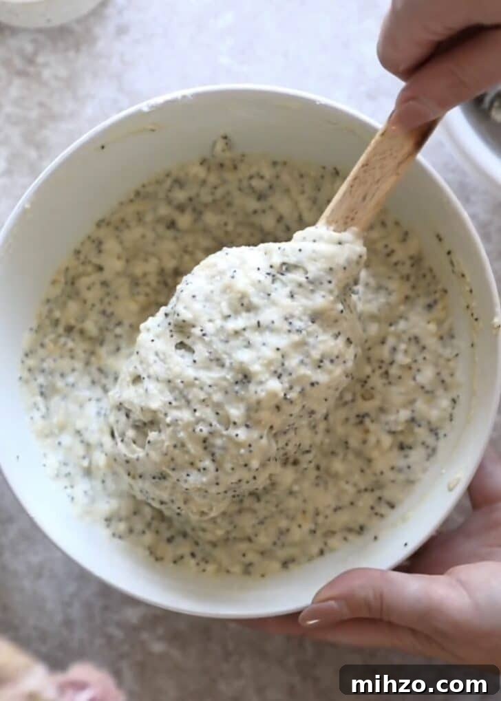Ricotta Lemon Poppy Seed Muffins with Zesty Citrus Glaze 12 Mixing batter with a rubber spatula.