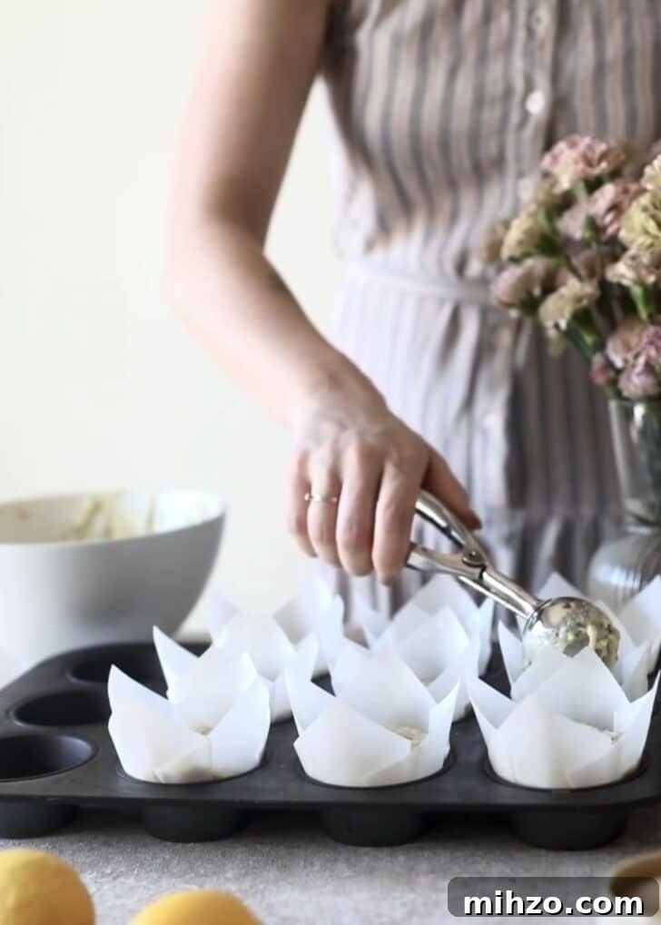 Ricotta Lemon Poppy Seed Muffins with Zesty Citrus Glaze 13 Scooping batter into liners.
