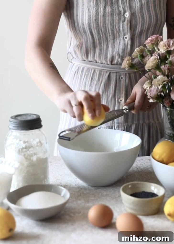 Ricotta Lemon Poppy Seed Muffins with Zesty Citrus Glaze 4 A woman zoning lemons into a bowl.