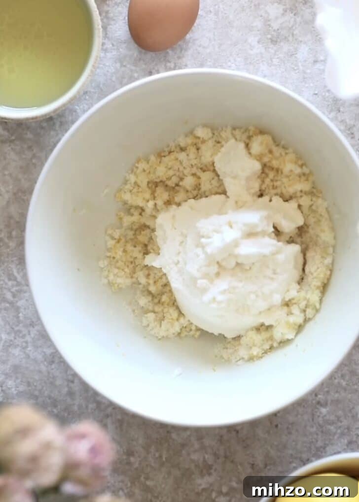 Ricotta Lemon Poppy Seed Muffins with Zesty Citrus Glaze 8 Lemon sugar and ricotta in a bowl.