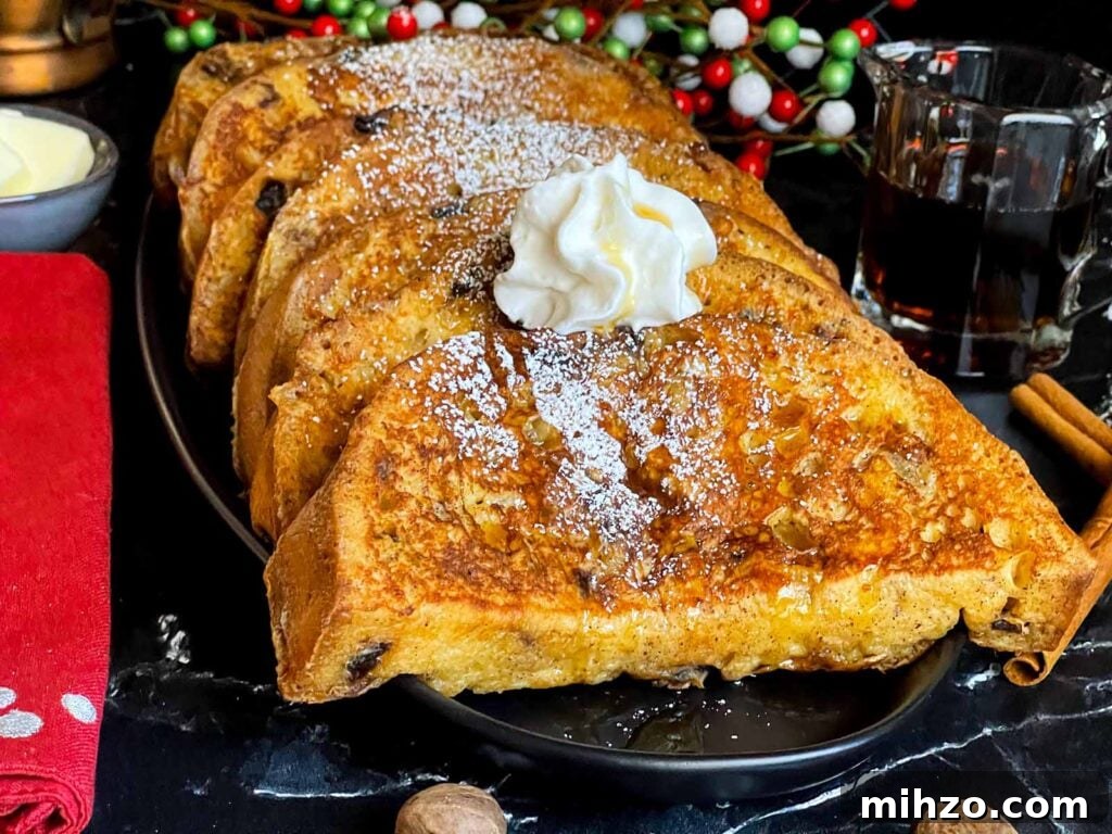 Decadent Panettone French Toast Recipe for Brunch 2 Slices of panettone French toast garnished with powdered sugar, whipped cream, and maple syrup on a dark plate.
