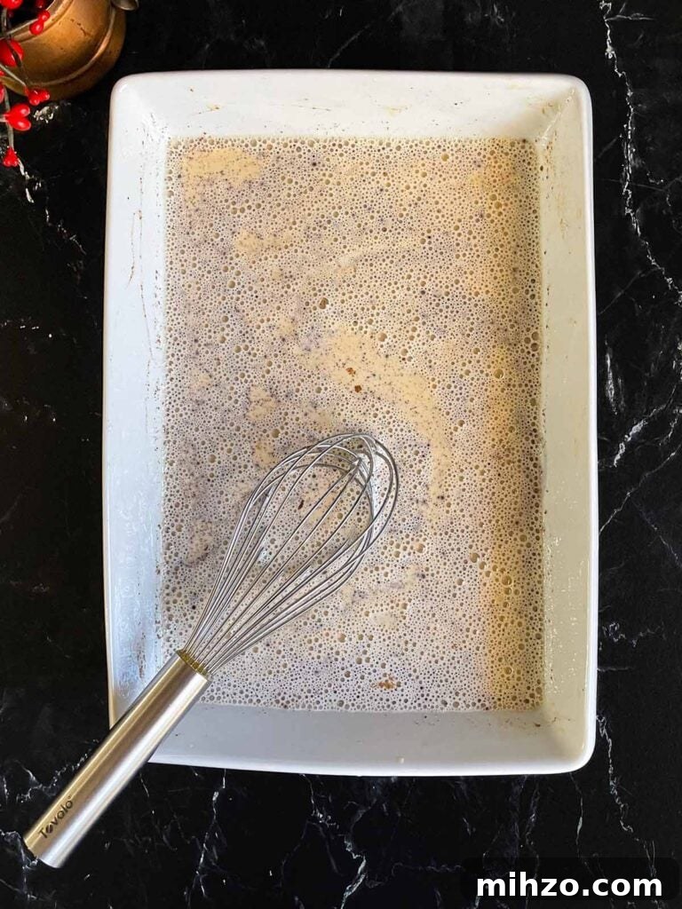 Decadent Panettone French Toast Recipe for Brunch 5 Panettone french toast egg mixture ingredients whisked together in a shallow baking dish.