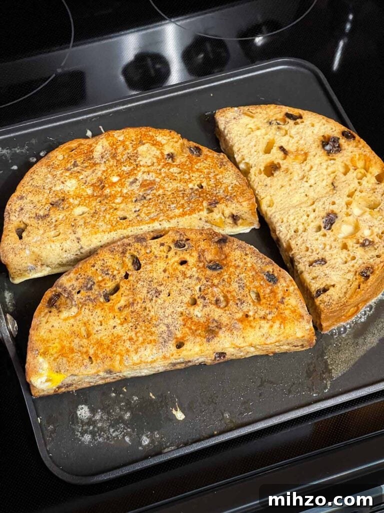 Decadent Panettone French Toast Recipe for Brunch 7 Slices of panettone french toast cooking on a buttered griddle.