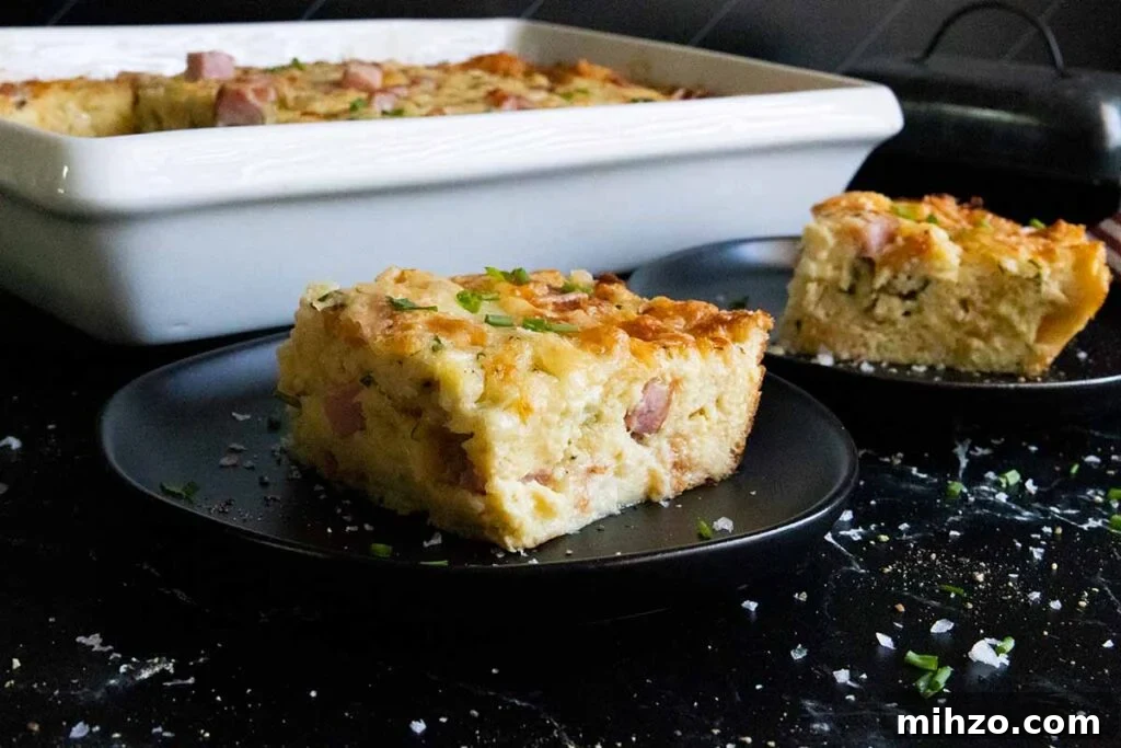 Decadent Panettone French Toast Recipe for Brunch 10 Ham and cheese strata slice on black plate.