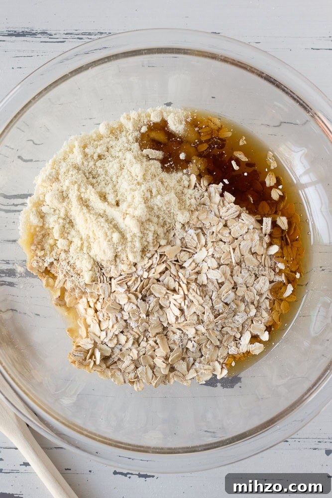 Unmixed crisp topping in a large clear mixing bowl.