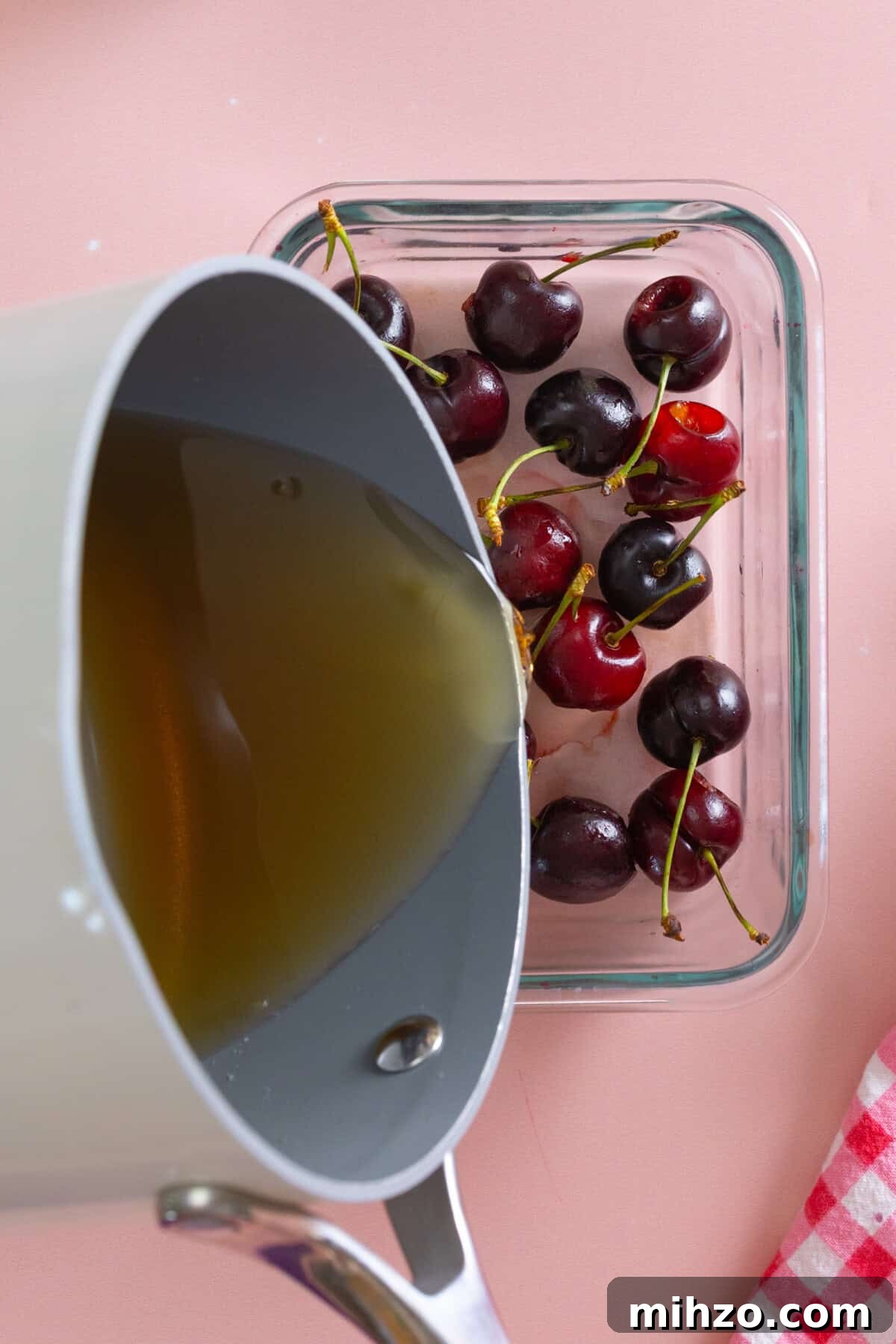 pouring brandy syrup over cherries