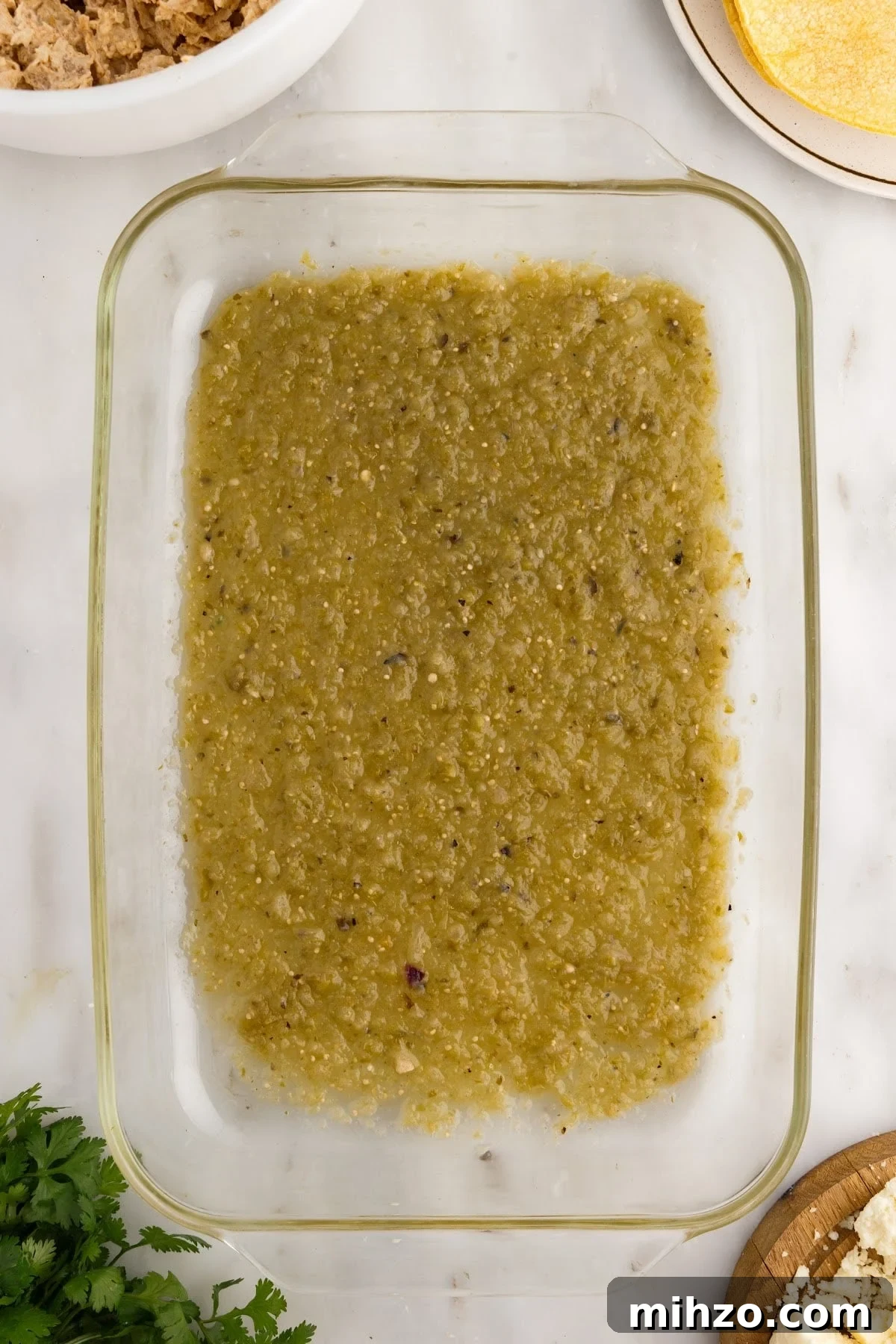 Enchilada sauce in the bottom of a 9x13.