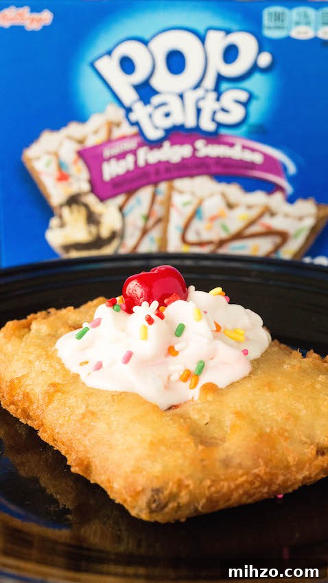 Crispy Deep-Fried Pop-Tarts Recipe: How to Make Them at Home 3 Close up of a homemade deep fried pop-tart that has been topped with whipped cream, sprinkles, and a cherry.