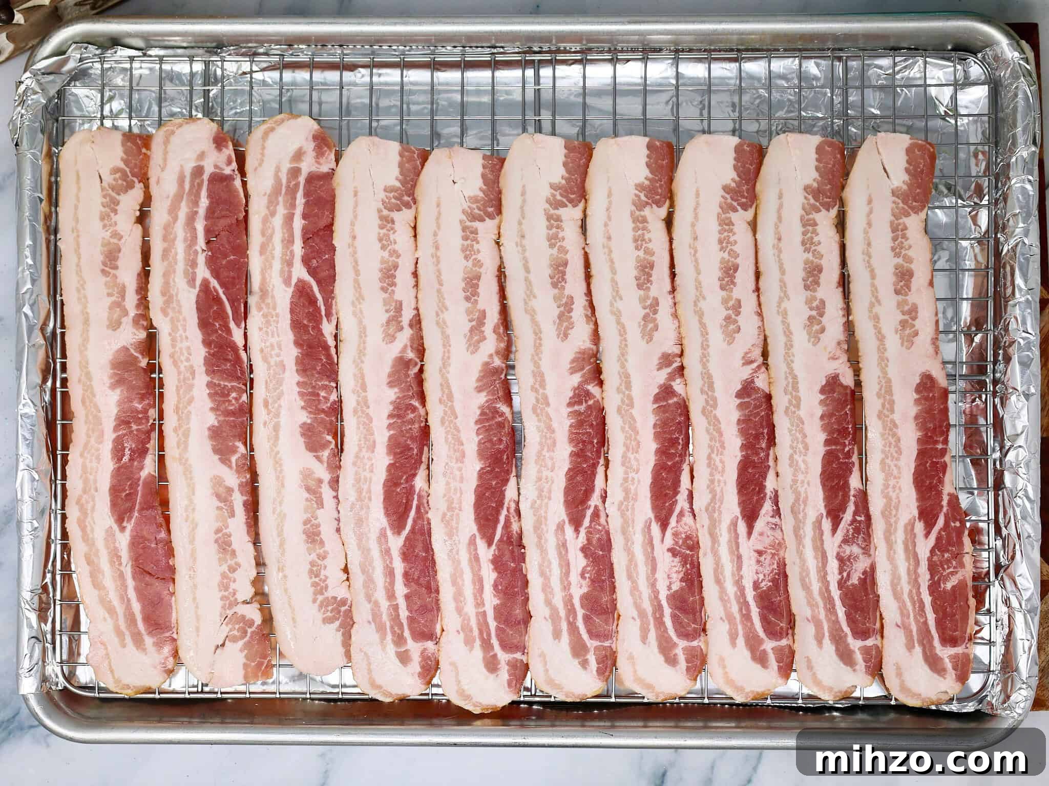 How to Make Perfect Crispy Bacon in the Oven 4 strips of bacon on an oven tray
