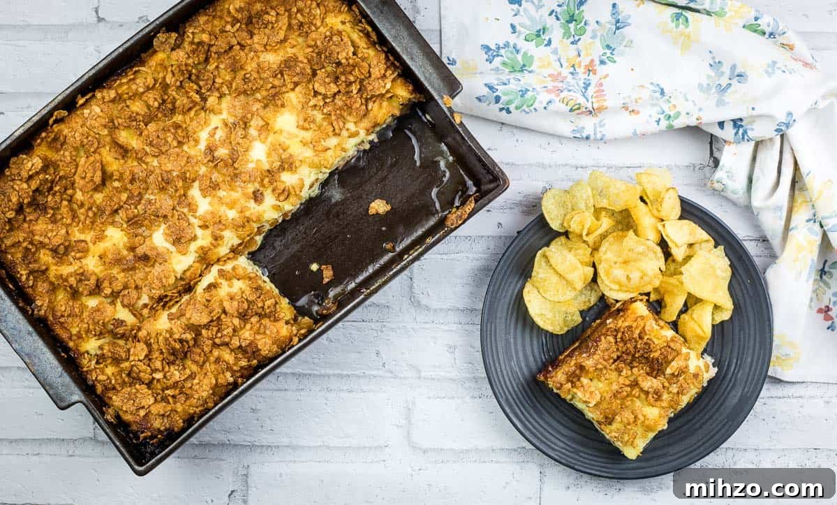 Cubano Sandwich Casserole and 12 Hearty Family Casseroles 2 A piece of Cuban sandwich casserole on a plate with potato chips.