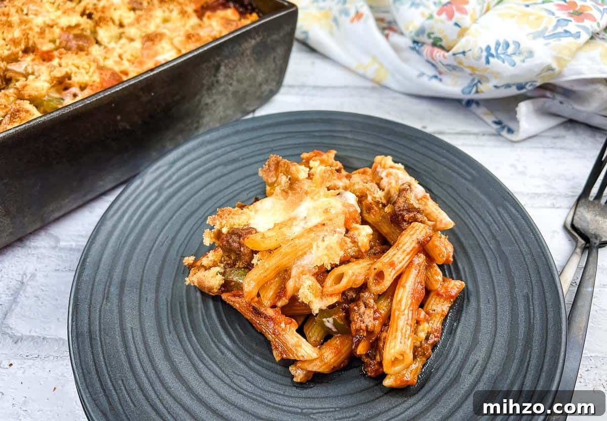 Cubano Sandwich Casserole and 12 Hearty Family Casseroles 13 A serving of Sloppy Joe Casserole pasta with meat on a plate with a fork.