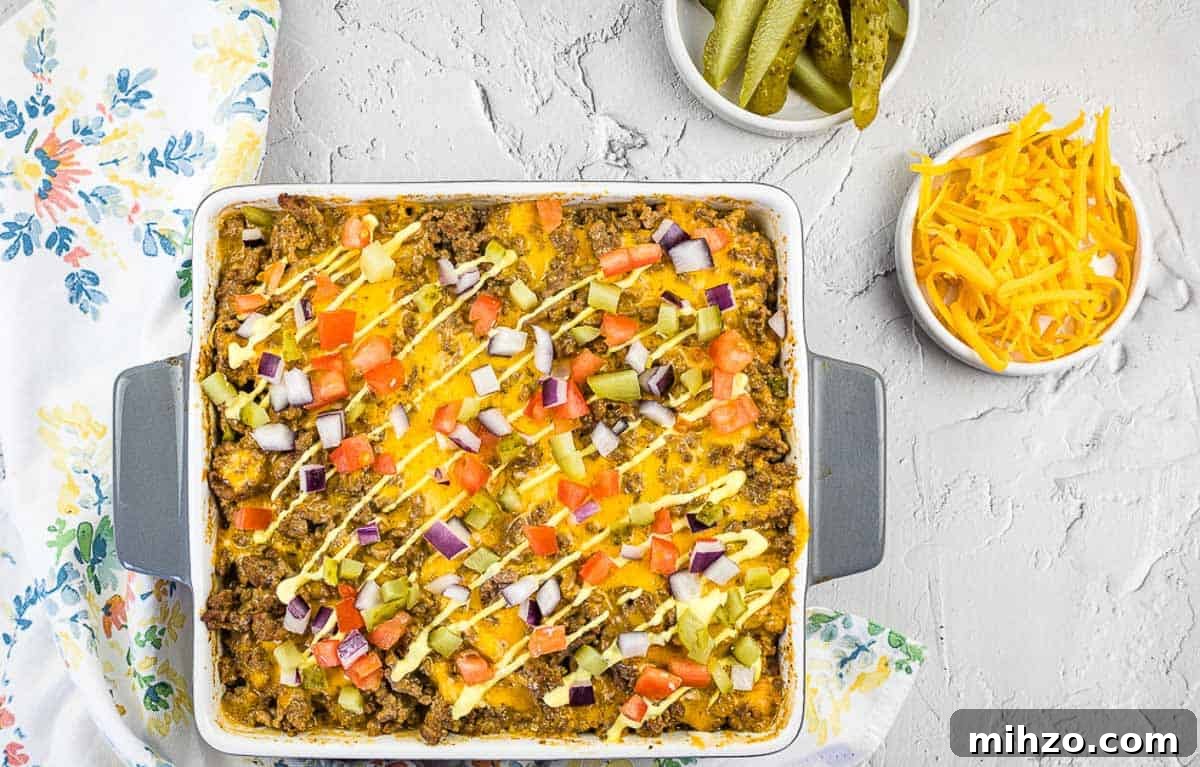 Cubano Sandwich Casserole and 12 Hearty Family Casseroles 4 A top-down shot of Cheeseburger Casserole with pickles and cheese nearby.