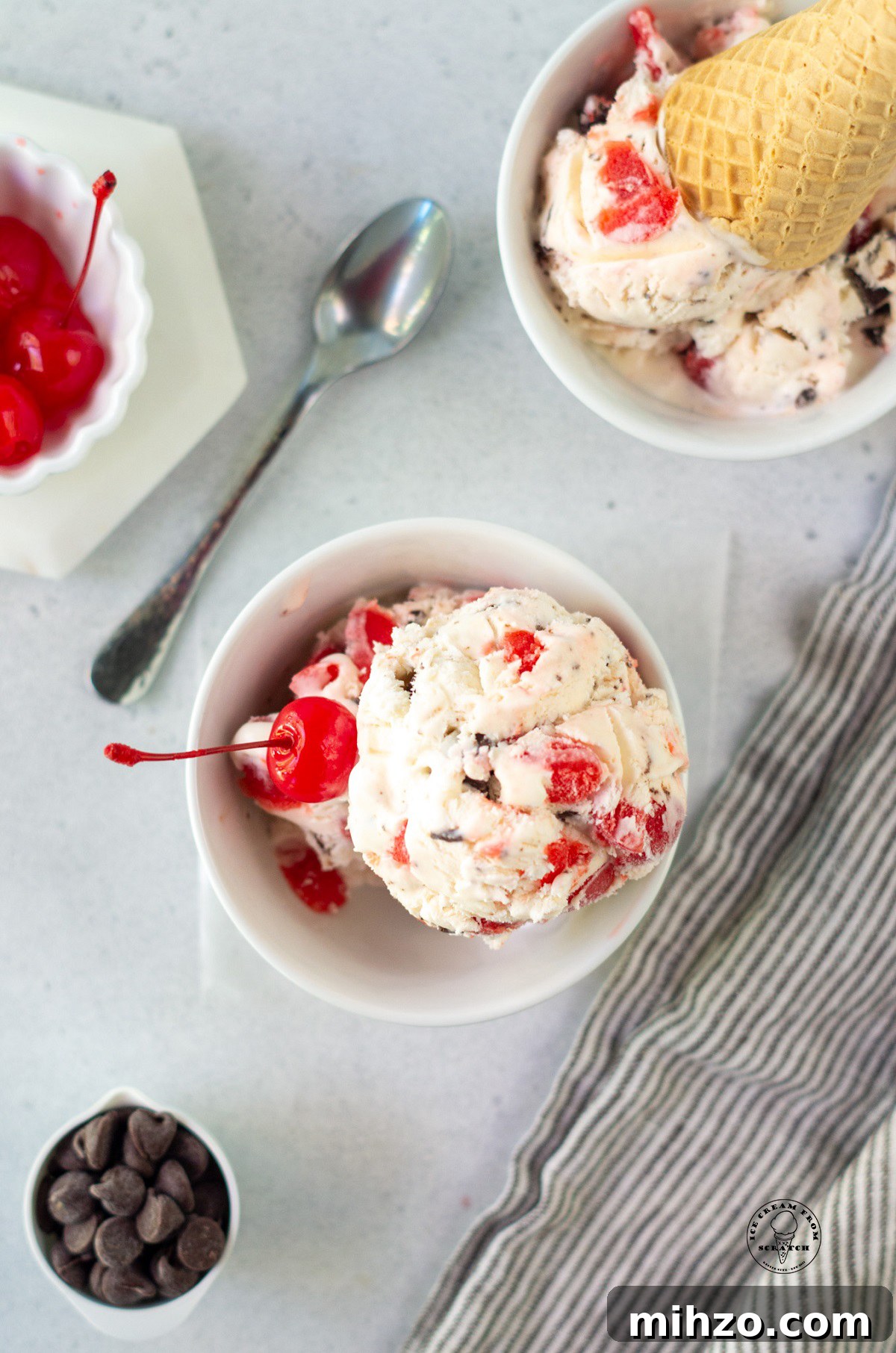 a bowl of cherry cordial ice cream topped with a maraschino cherry.