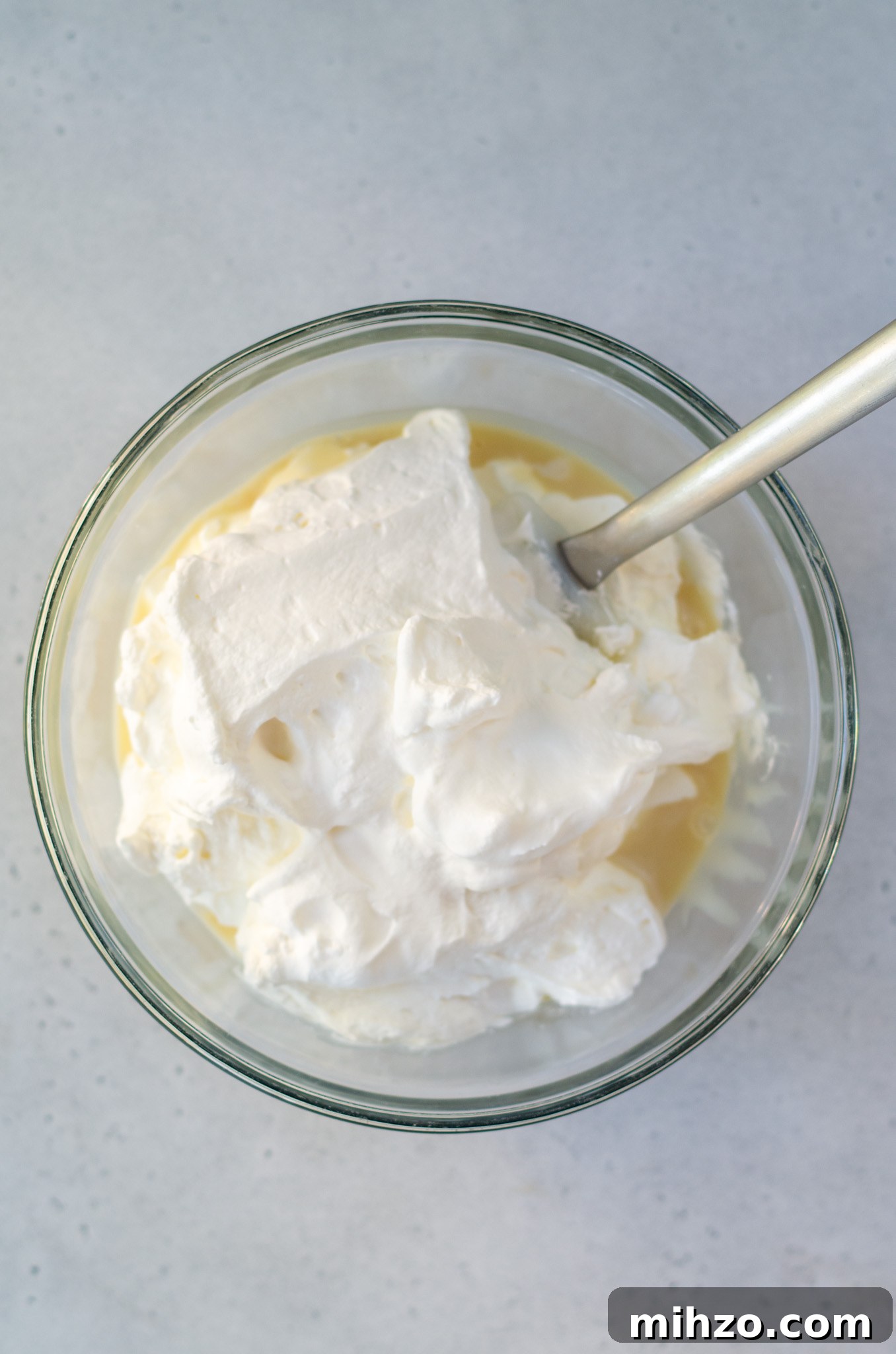 sweetened condensed milk and whipped cream in a bowl