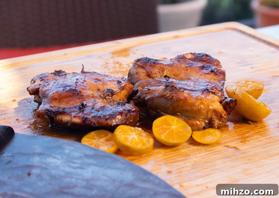 Ninja Woodfire Filipino-Style BBQ Chicken Thighs 2 ninja woodfire chicken thighs on a cutting board
