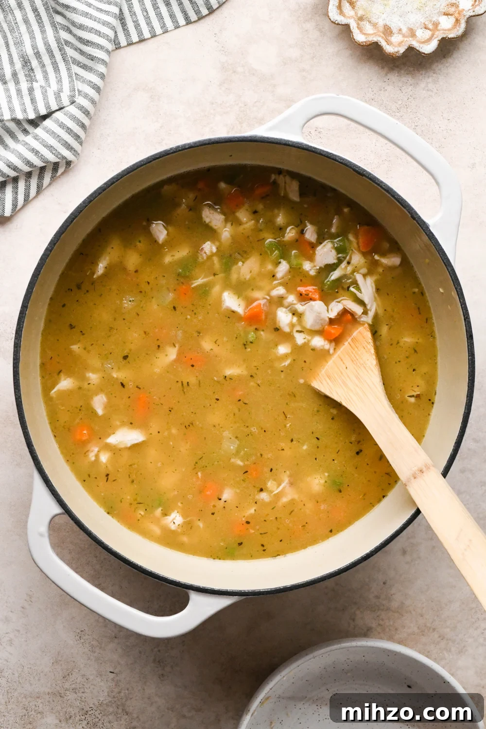 Delicious Dairy-Free Chicken and Broccoli Soup Recipe 12 How to make Chicken and Broccoli Soup: Soup stirred together with broth and chicken, before continuing to simmer.