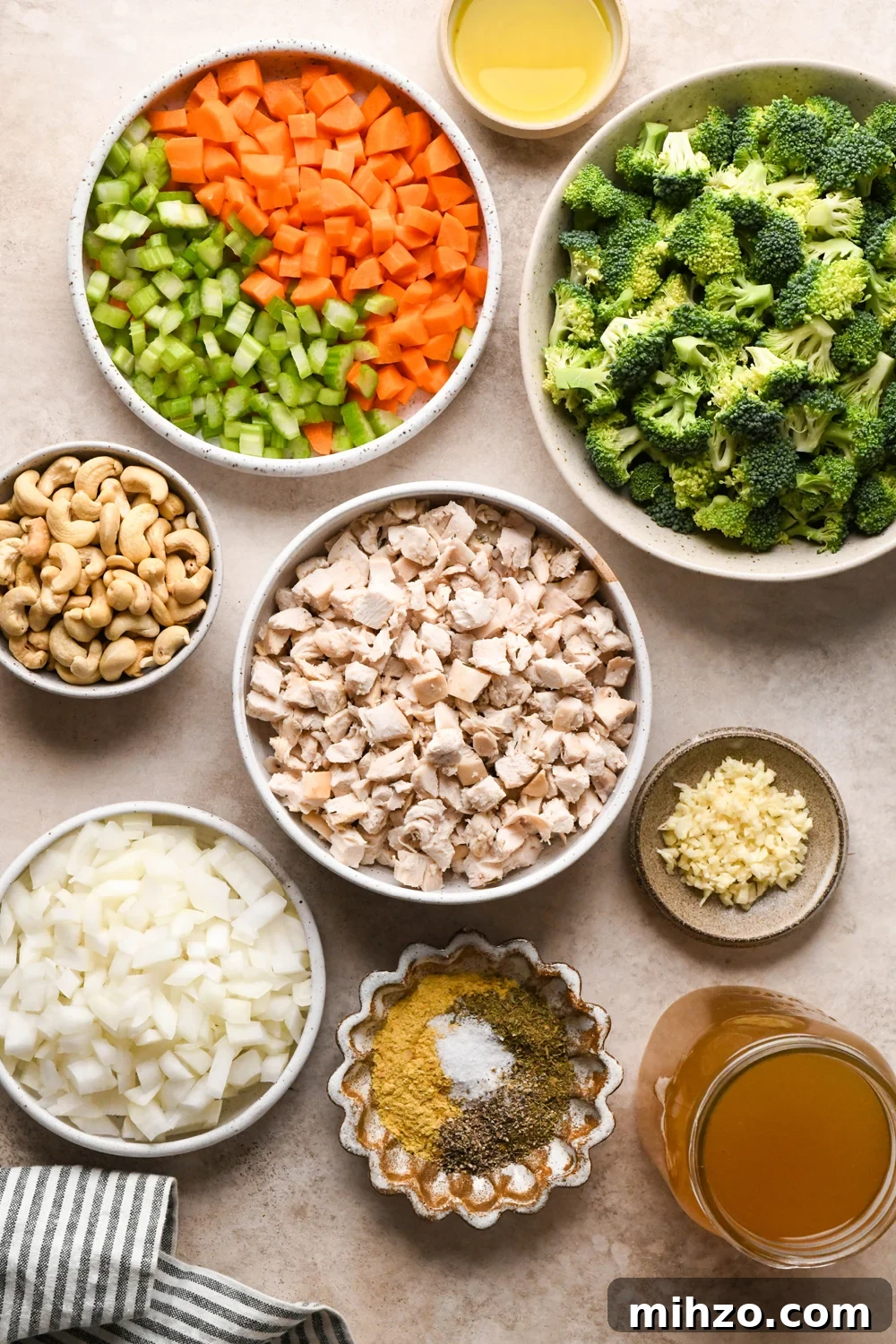 Delicious Dairy-Free Chicken and Broccoli Soup Recipe 4 Ingredients for chicken and broccoli soup in various ceramics on a light creamy brown background.