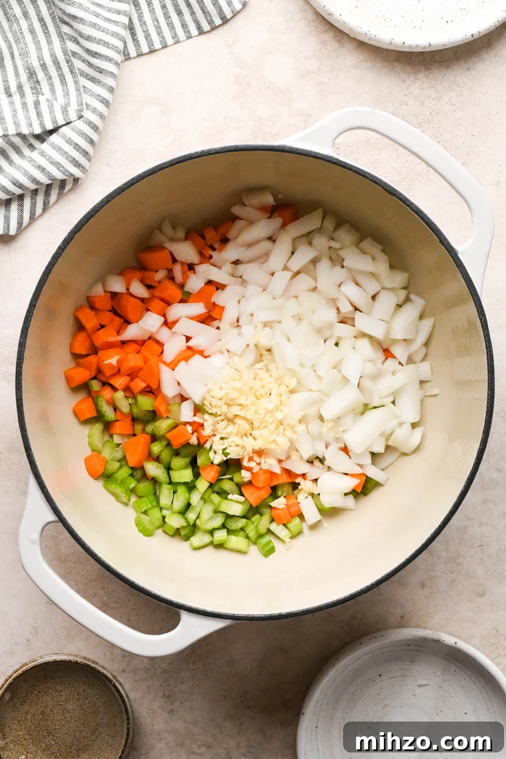 Delicious Dairy-Free Chicken and Broccoli Soup Recipe 7 How to make Chicken and Broccoli Soup: Diced carrots, diced celery, diced onion, and chopped garlic in a large off-white ceramic soup pot with olive oil, before sautéing.