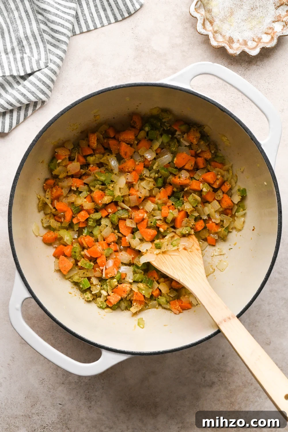 Delicious Dairy-Free Chicken and Broccoli Soup Recipe 9 How to make Chicken and Broccoli Soup: Spices and nutritional yeast stirred into the sautéed veggies in a large off-white ceramic soup pot.