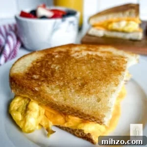 Sourdough Breakfast Sandwich Ideas for Quick Morning Meals 12 One half of a sourdough breakfast sandwich on a small plate.