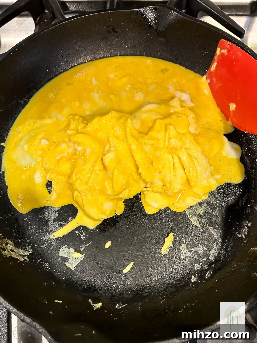 Sourdough Breakfast Sandwich Ideas for Quick Morning Meals 8 Fluffy scrambled eggs in a non-stick skillet.