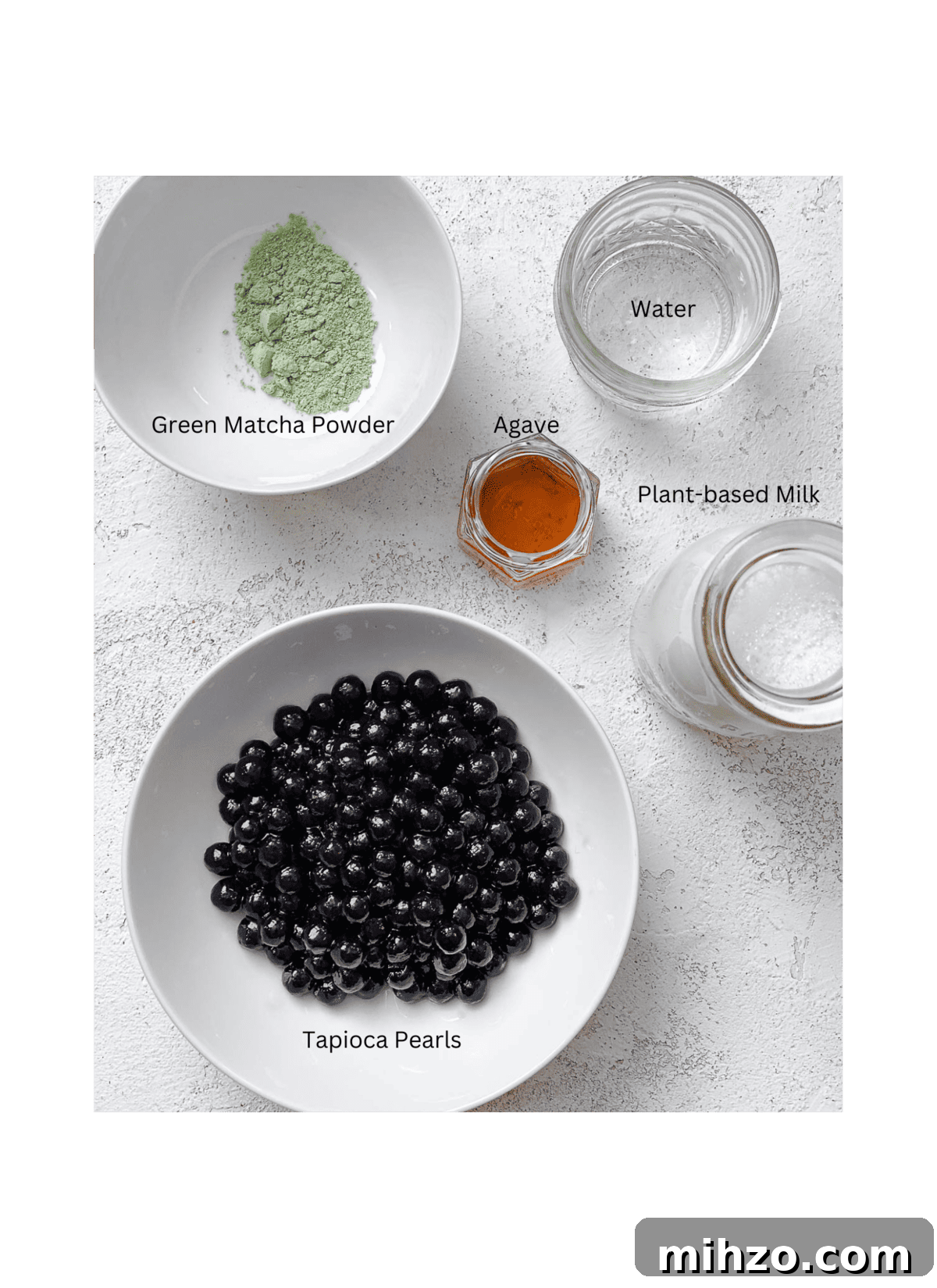 ingredients for Matcha Boba Tea (Green Milk Tea) measured out against a white surface