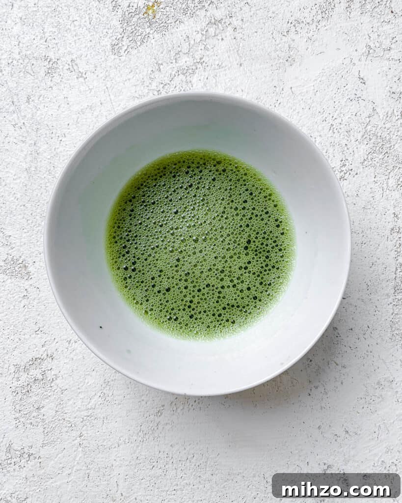 process shot of mixing matcha powder together in a bowl
