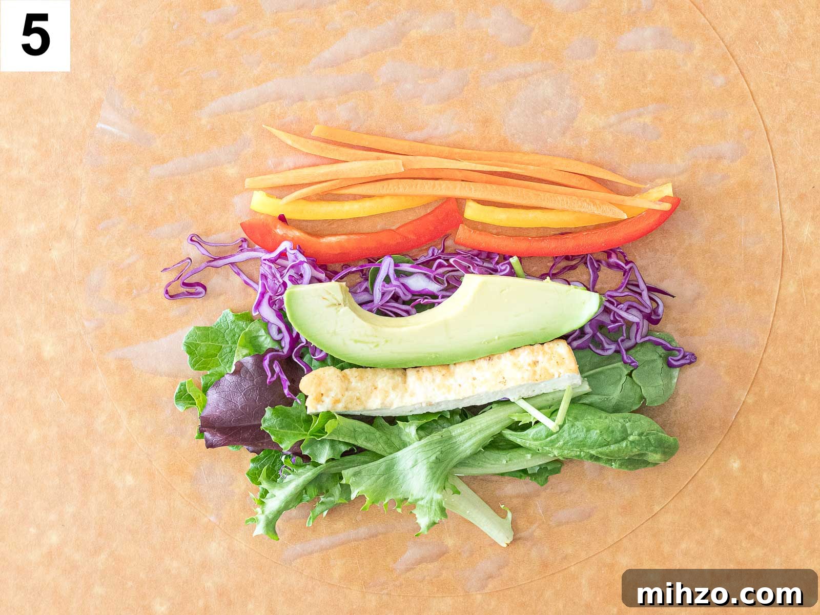 avocado, tofu, and rainbow veggies on a rice paper wrapper
